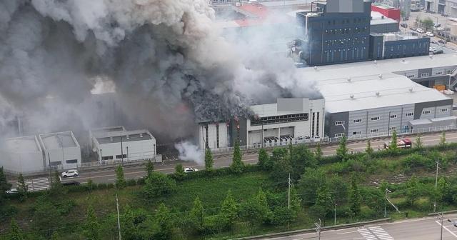 Smoke rises from a primary battery manufacturing plant hit by a fire in Hwaseong, south of Seoul, on June 24, 2024. Yonhap