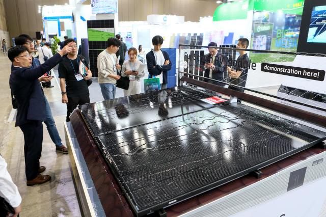 Visitors listen to a booth official at Expo Solar  PV Korea 2024 at KINTEX in Goyang west of Seoul on June 11 2024 AJU PRESS Kim Dong-woo