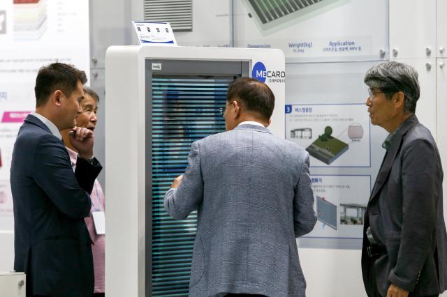 Visitors listen to a booth official at Expo Solar  PV Korea 2024 at KINTEX in Goyang west of Seoul on June 25 2024 AJU PRESS Kim Dong-woo