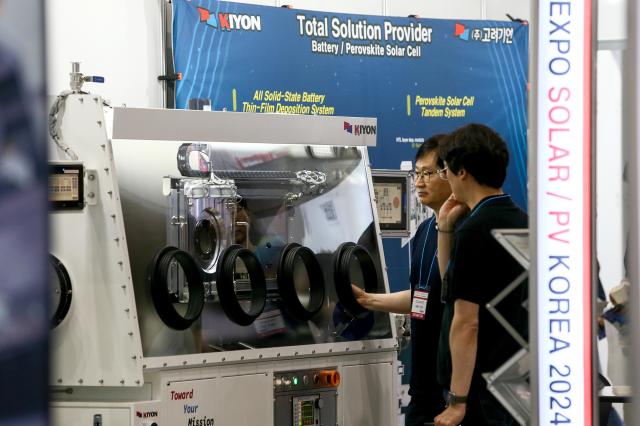 A visitor listen to a booth official at Expo Solar  PV Korea 2024 at KINTEX in Goyang west of Seoul on June 25 2024 AJU PRESS Kim Dong-woo