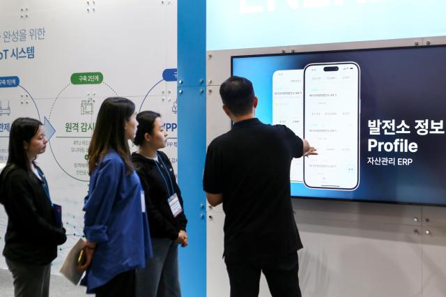 Visitors listen to a booth official at Expo Solar  PV Korea 2024 at KINTEX in Goyang west of Seoul on June 25 2024 AJU PRESS Kim Dong-woo