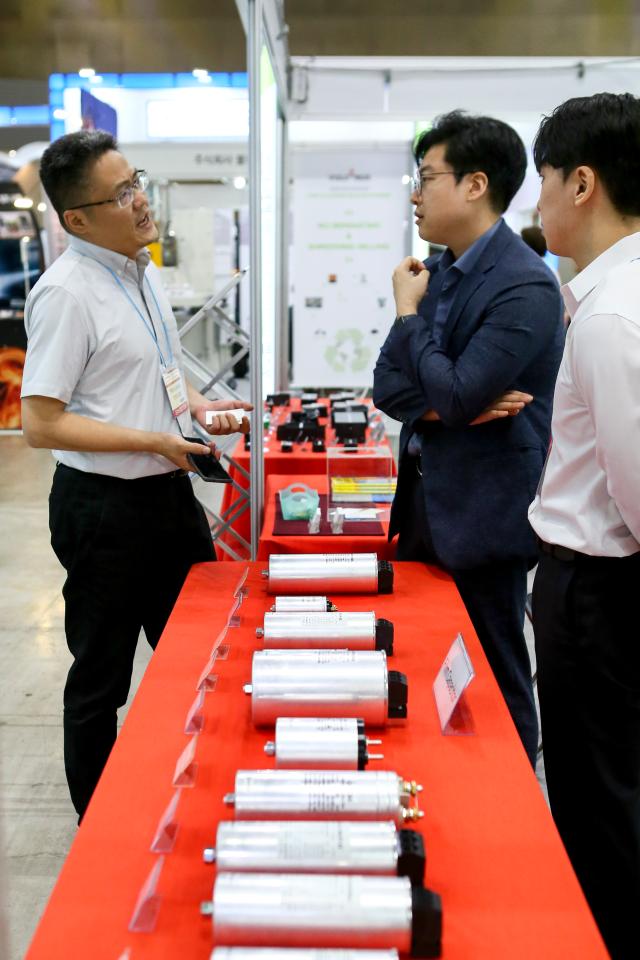 Visitors listen to a booth official at Expo Solar  PV Korea 2024 at KINTEX in Goyang west of Seoul on June 25 2024 AJU PRESS Kim Dong-woo