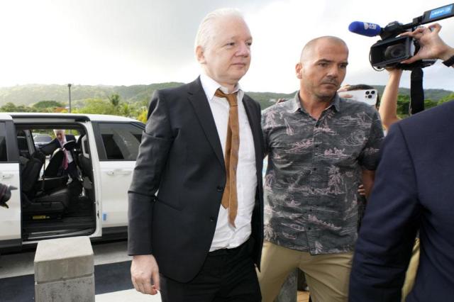 WikiLeaks founder Julian Assange left is escorted as he arrives at the United States courthouse in Saipan Mariana Islands on June 26 2024 AP-Yonhap