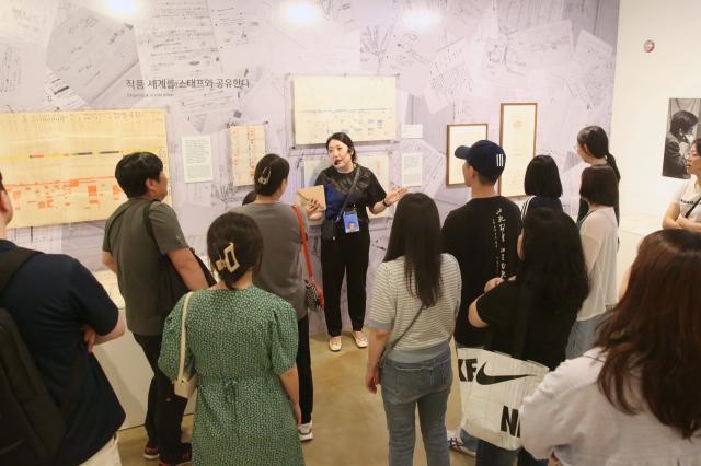 A docent explains the exhibition to visitors at the Studio Ghibli - Isao Takahata Exhibition held at the Sejong Center in Seoul on June 26 2024 AJU PRESS Han Jun-gu