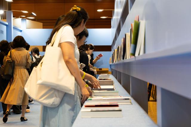 Visitors examine books displayed at the Houyhnhnm theme exhibition during the Seoul International Book Fair 2024 at COEX in Gangnam Seoul on June 26, 2024. AJU PRESS Park Jong-hyeok