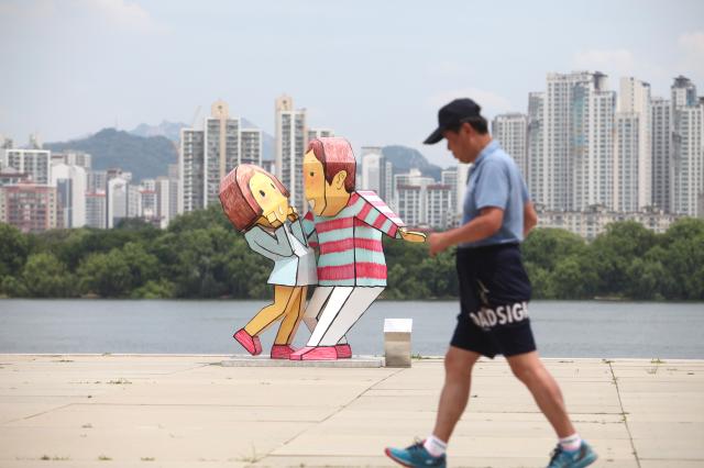 A visitor walks beside Gyeonsaeng sculpture installations at Yeouido Hangang Park in Seoul on June 27 2024 AJU PRESS Han Jun-gu