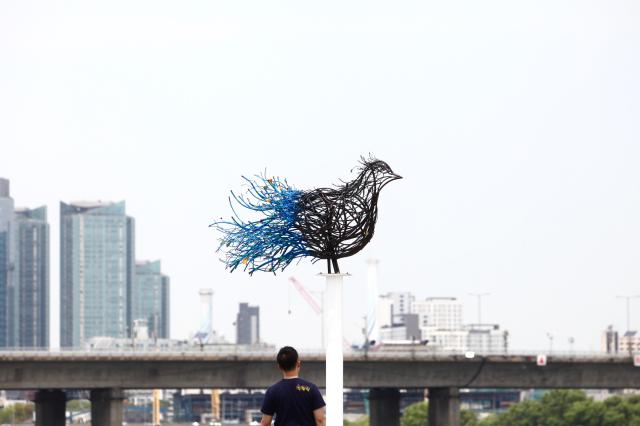 A visitor views Gyeonsaeng sculpture exhibition installations at Yeouido Hangang Park in Seoul on June 27 2024 AJU PRESS Han Jun-gu