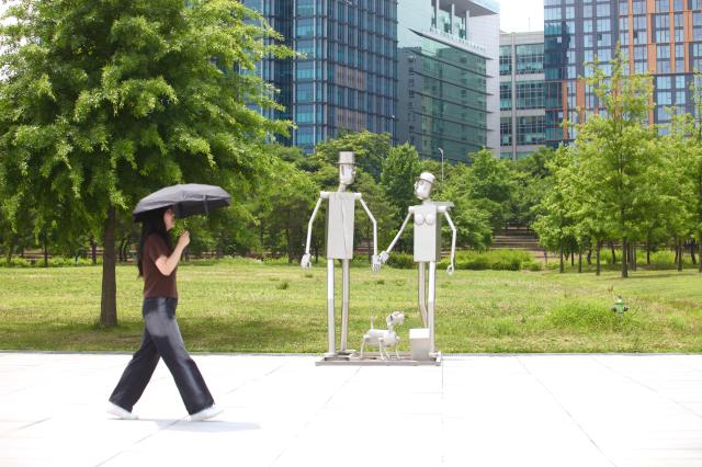 A visitor walks beside Gyeonsaeng sculpture installations at Yeouido Hangang Park in Seoul on June 27 2024 AJU PRESS Han Jun-gu