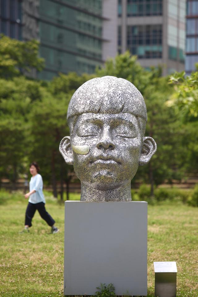 A visitor walks beside Gyeonsaeng sculpture installations at Yeouido Hangang Park in Seoul on June 27 2024 AJU PRESS Han Jun-gu