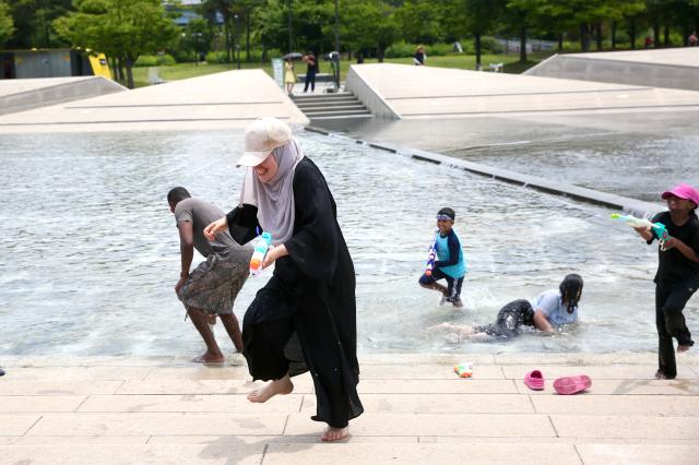 Visitors play in the Cascade Fountain at Yeouido Hangang Park in Seoul on June 27 2024 AJU PRESS Han Jun-gu