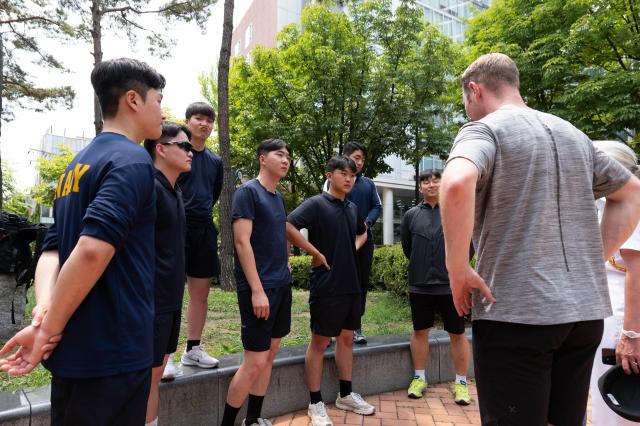 Korean Navy players listen to pre-game instructions at Jeongdong Park in central Seoul July 1 2024 AJU PRESS Park Jong-hyeok