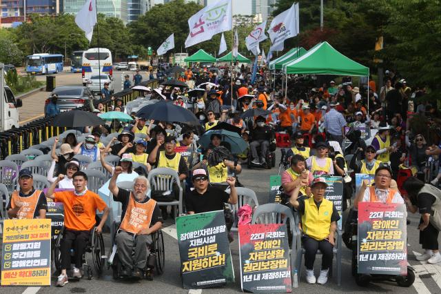 Protesters chant slogans and clench their fists during the Move Toward Parade organized by the Solidarity Against Disability Discrimination in front of the National Assembly on July 1 2024 AJU PRESS Han Jun-gu