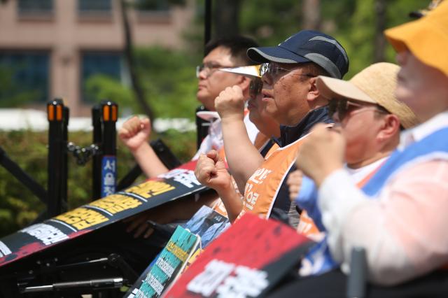 Protesters chant slogans and clench their fists during the Move Toward Parade organized by the SADD in front of the National Assembly on July 1 2024 AJU PRESS Han Jun-gu