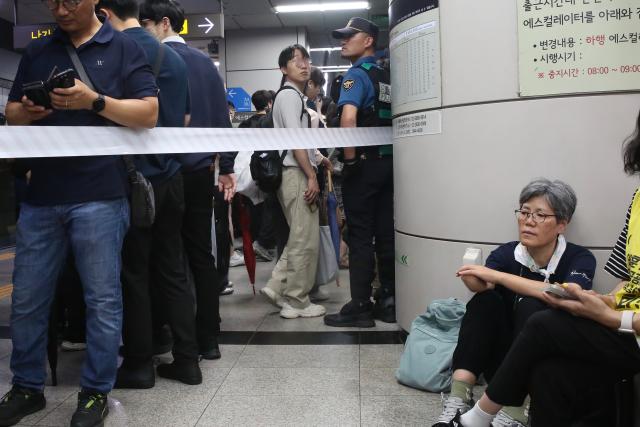 People walk past seated protesters during the Move Toward Parade organized by SADD at the National Assembly station platform on July 2 2024 AJU PRESS Han Jun-gu