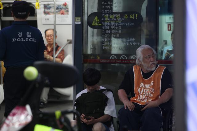 Representative Park Kyung-suk sits in a wheelchair in front of an open subway door during the Move Toward Parade organized by SADD at the National Assembly station platform on July 2 2024 AJU PRESS Han Jun-gu