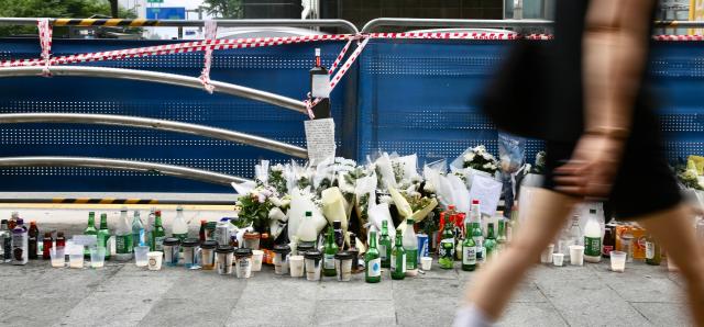 Flowers and bottles of alcohol left by people are placed at the accident site near City Hall Station in Seoul on July 4 2024 AJU PRESS Han Jun-gu