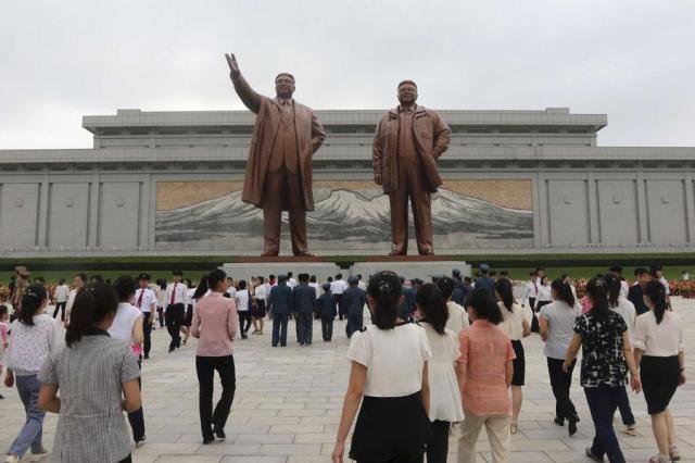 People gather to pay respects to the statues of former leaders in Pyongyang on July 7 2024 AP-Yonhap