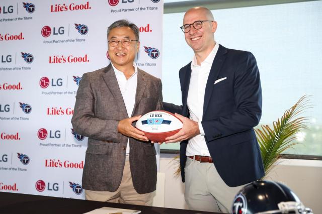 LG Electronics North America CEO Jae-kwang Jeong left and Titans COO Dan Werly right at sponsorship renewal ceremony Courtesy of LG Electronics