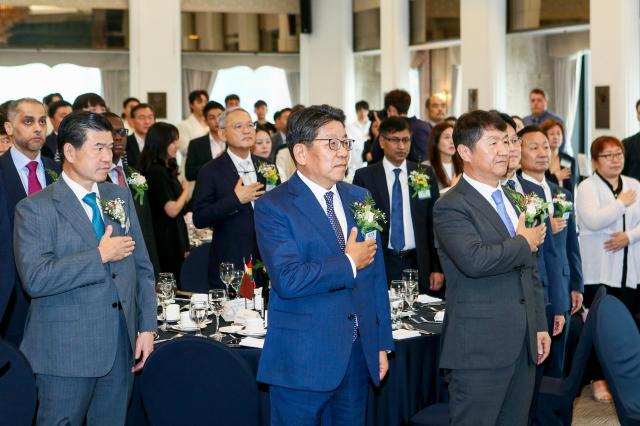 L-R James Kim AMCHAM Chairman  CEO Choi Jin-young Foreign Language Newspapers Association of Korea chairman Oh Young-jin The Korea Times President-Publisher and Attendees salute the flag during the 9th anniversary celebration of the Foreign Language Newspapers Association of Korea at the Korea Press Center on July 9 2024 AJU PRESS Kim Dong-woo