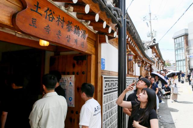 A visitor takes a photo at the Samgyetang restaurant in Jongno-gu Seoul on July 15 2024 AJU PRESS Kim Dong-woo