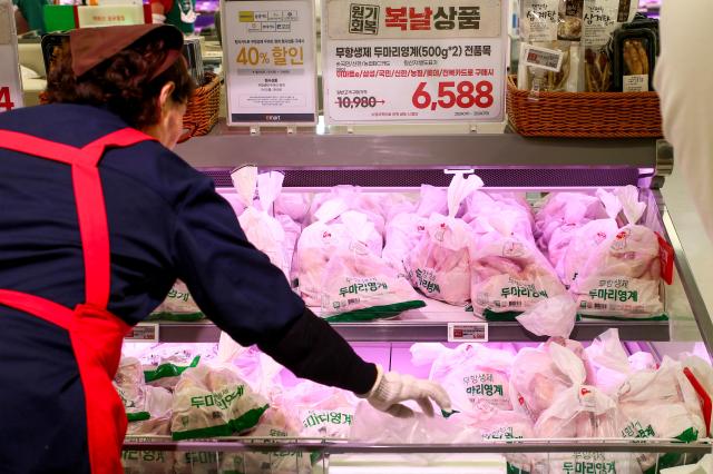 An employee displays raw chicken at a supermarket in Yongsan-gu Seoul on July 15 2024 AJU PRESS Kim Dong-woo