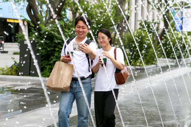 Visitors cool off at Gwanghwamun Plaza in Jongno central Seoul during a summer day on July 15 2024 AJU PRESS Kim Dong-woo