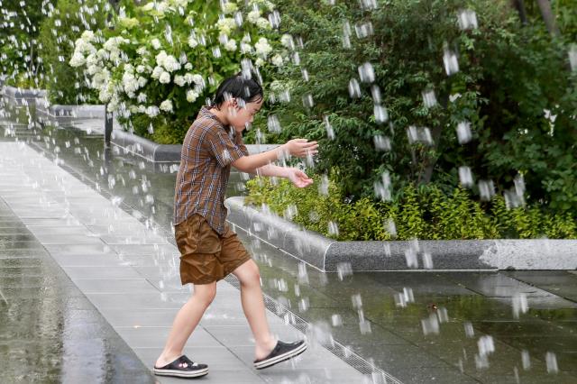 Visitors cool off at Gwanghwamun Plaza in Jongno central Seoul during a summer day on July 15 2024 AJU PRESS Kim Dong-woo