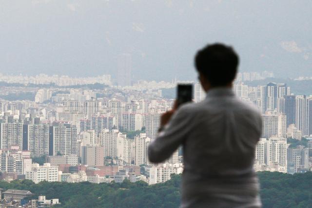 A visitor takes a photo cityscape in Namsan Seoul on July 16 2024 