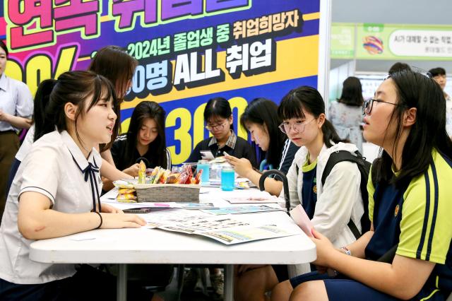 Students listen to a booth representative explain career paths at the 2024 Seoul Career Fair at the Dongdaemun Design Plaza in Seoul on July 18 2024 AJU PRESS Kim Dong-woo