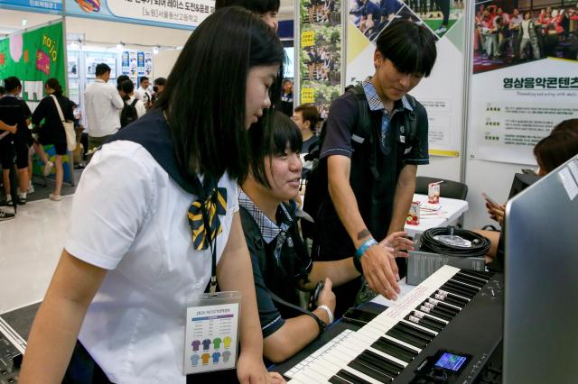 Students listen to a booth representative explain career paths at the 2024 Seoul Career Fair at the Dongdaemun Design Plaza in Seoul on July 18 2024 AJU PRESS Kim Dong-woo