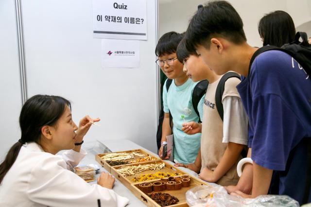 Students listen to a booth representative explain career paths at the 2024 Seoul Career Fair at the Dongdaemun Design Plaza in Seoul on July 18 2024 AJU PRESS Kim Dong-woo