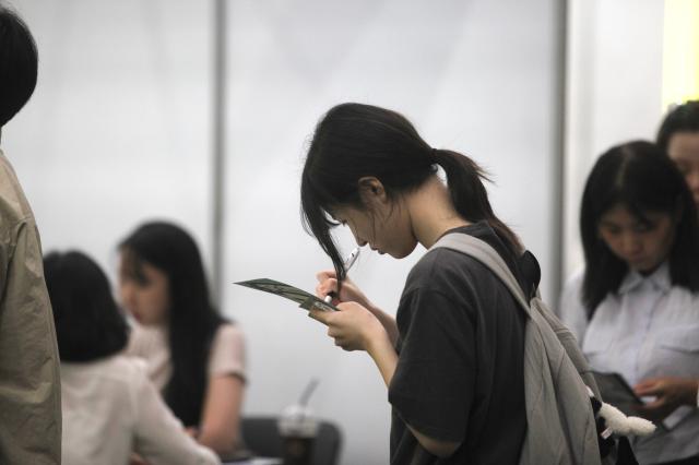 A student takes notes at the 2025 University Early Admission Expo held at KINTEX in Goyang west of Seoul on July 19 2024 AJU PRESS Han Jun-gu