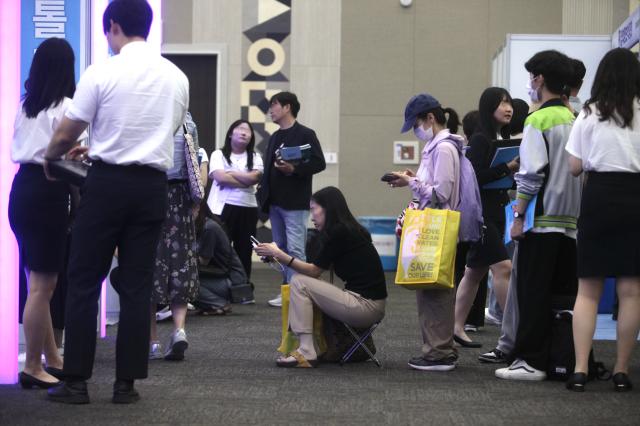 A visitor sits in a chair waiting for a consultation at the 2025 University Early Admission Expo held at KINTEX in Goyang west of Seoul on July 19 2024 AJU PRESS Han Jun-gu