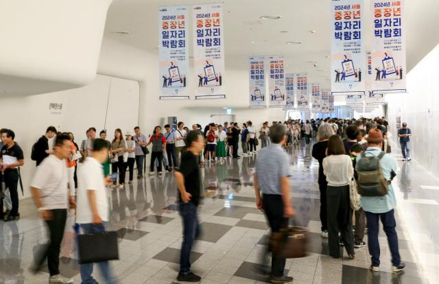 Visitors wait in a long queue to enter the 4050 Job Fair at Dongdaemun Design Plaza in Seoul on July 22 2024 AJU PRESS Kim Dong-woo