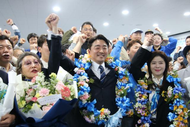 충남 아산을 더불어민주당 강훈식 당선인중앙이 11일 자신의 선거사무소에서 꽃다발을 걸고 환호하고 있다 사진연합뉴스