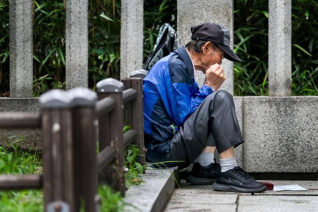 A senior citizen plays a harmonica at Pagoda Park in Jongno-gu Seoul on July 23 2024 AJU PRESS Kim Dong-woo