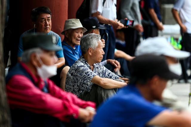 Senior citizens sit and rest at Pagoda Park in Jongno-gu Seoul on July 23 2024 AJU PRESS Kim Dong-woo