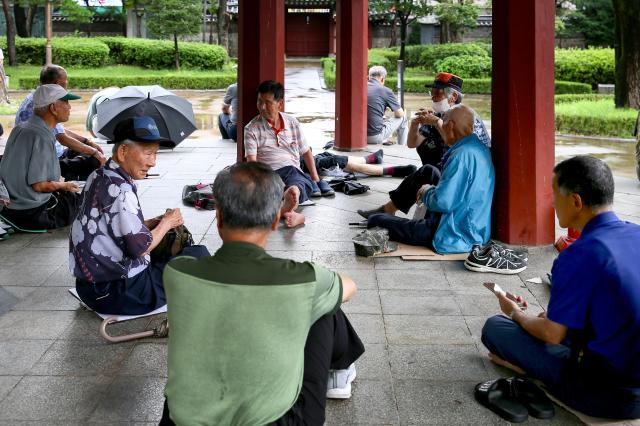 Senior citizens sit in an octagonal pavilion at Pagoda Park in Jongno-gu Seoul on July 23 2024 AJU PRESS Kim Dong-woo