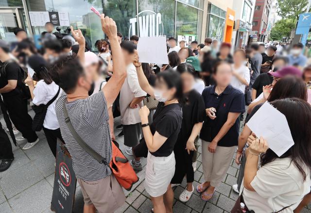 Victims discuss countermeasures outside Tmon headquarters in Gangnam Seoul demanding to meet with employees Yonhap