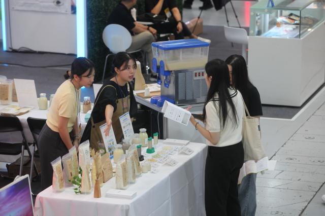 An official explains products to a visitor at the Agri  Food Tech Start-up Rising Expo 2024 AFRO 2024 held at COEX in Seoul on July 25 2024 AJU PRESS Han Jun-gu 