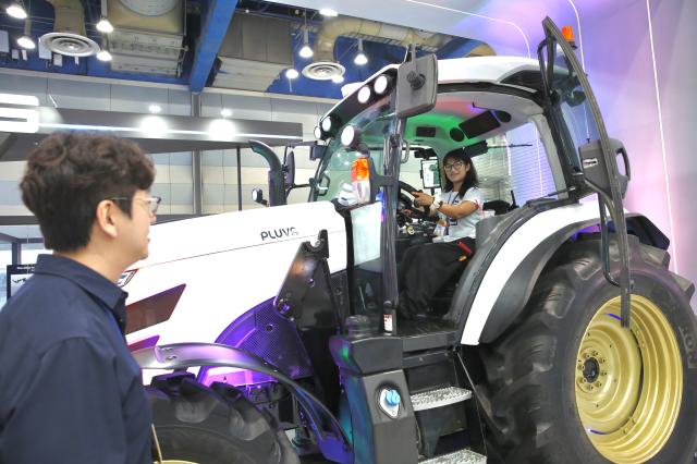 A visitor sits on a tractor at the Agri  Food Tech Start-up Rising Expo 2024 AFRO 2024 held at COEX in Seoul on July 25 2024 AJU PRESS Han Jun-gu 