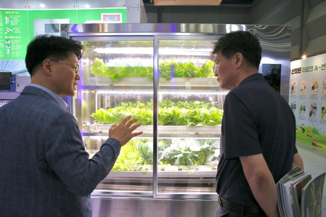 An official explains products to a visitor at the Agri  Food Tech Start-up Rising Expo 2024 AFRO 2024 held at COEX in Seoul on July 25 2024 AJU PRESS Han Jun-gu 