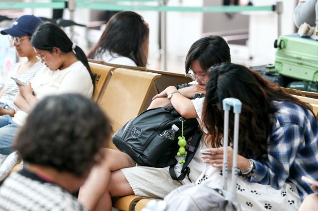 Travelers rest on a bench at Incheon International Airports Terminal 1 on July 26 2024 AJU PRESS Kim Dong-woo