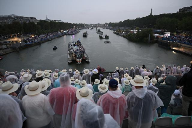 Boats carrying members of delegations sail along the Seine during the opening ceremony of the Paris 2024 Olympic Games in Paris France July 26 2024 XinhuaYonhap