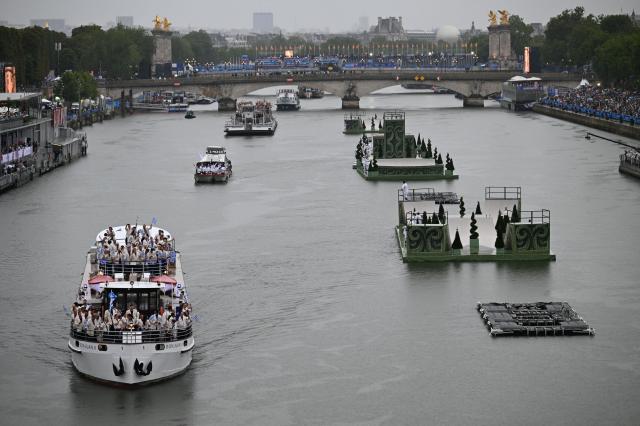 Boats carrying members of delegations sail along the Seine during the opening ceremony of the Paris 2024 Olympic Games on July 26 2024 AFPYonhap