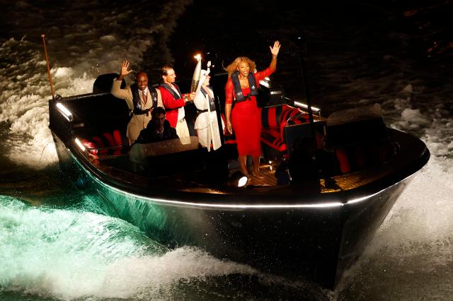 The Olympic torch is being taken down the Seine in a boat with L-R Carl Lewis Rafael Nadal Nadia Comaneci and Serena Williams during the Opening Ceremony of the Paris 2024 Olympic Games in Paris France 26 July 2024 EPAYonhap