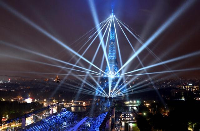 A general view of the Eiffel Tower and lasers lighting up the sky during the opening ceremony of the Paris 2024 Olympic Games in Paris on July 26 2024 AFPYonhap