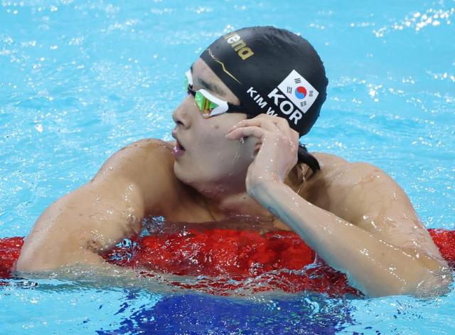 Swimmer Kim Woo-min reacts after checking his time in the mens 400-m freestyle at the Summer Olympics in Paris France on Saturday 