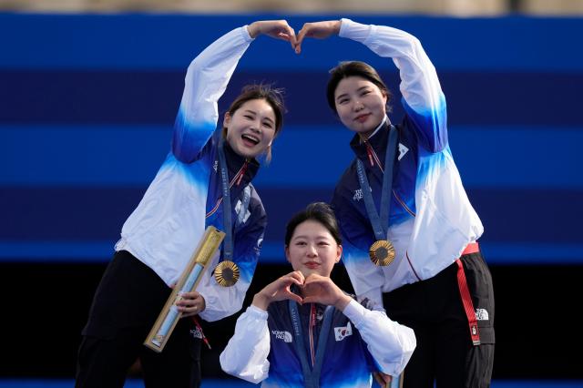 South Korean gold medal winnersJeon Hun-young left Lim Si-hyeon center Nam Su-hyeon right celebrate during womens team medal ceremony at the 2024 Summer Olympics in Paris July 28 2024 AP-Yonhap