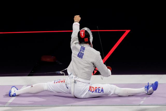 South Korean Oh Sang-uk celebrates after winning against Tunisias Fares Ferjani in the mens sabre individual gold medal bout during the Paris 2024 Olympic Games at the Grand Palais in Paris on July 27 2024 Yonhap